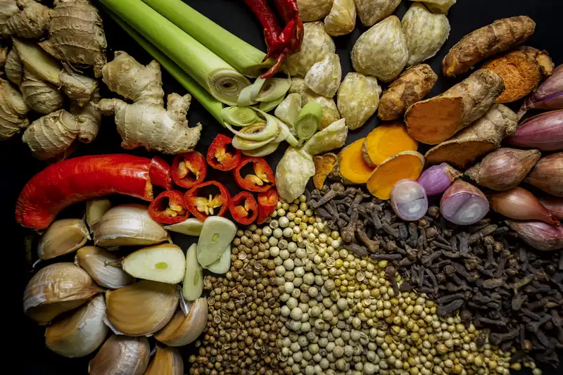 Assortment of Indonesian spices and aromatics: chillies, ginger, turmeric, pepper, shallots