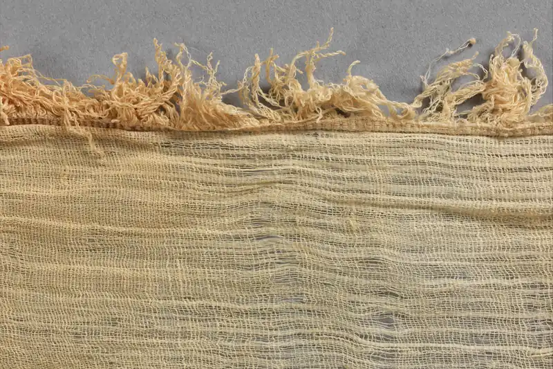 Fringed edge of an ancient Egyptian linen sheet, fine weave and sand colour