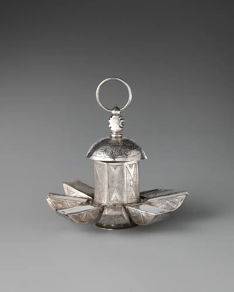 Silver pomander opened into segments like a flower, a museum piece
